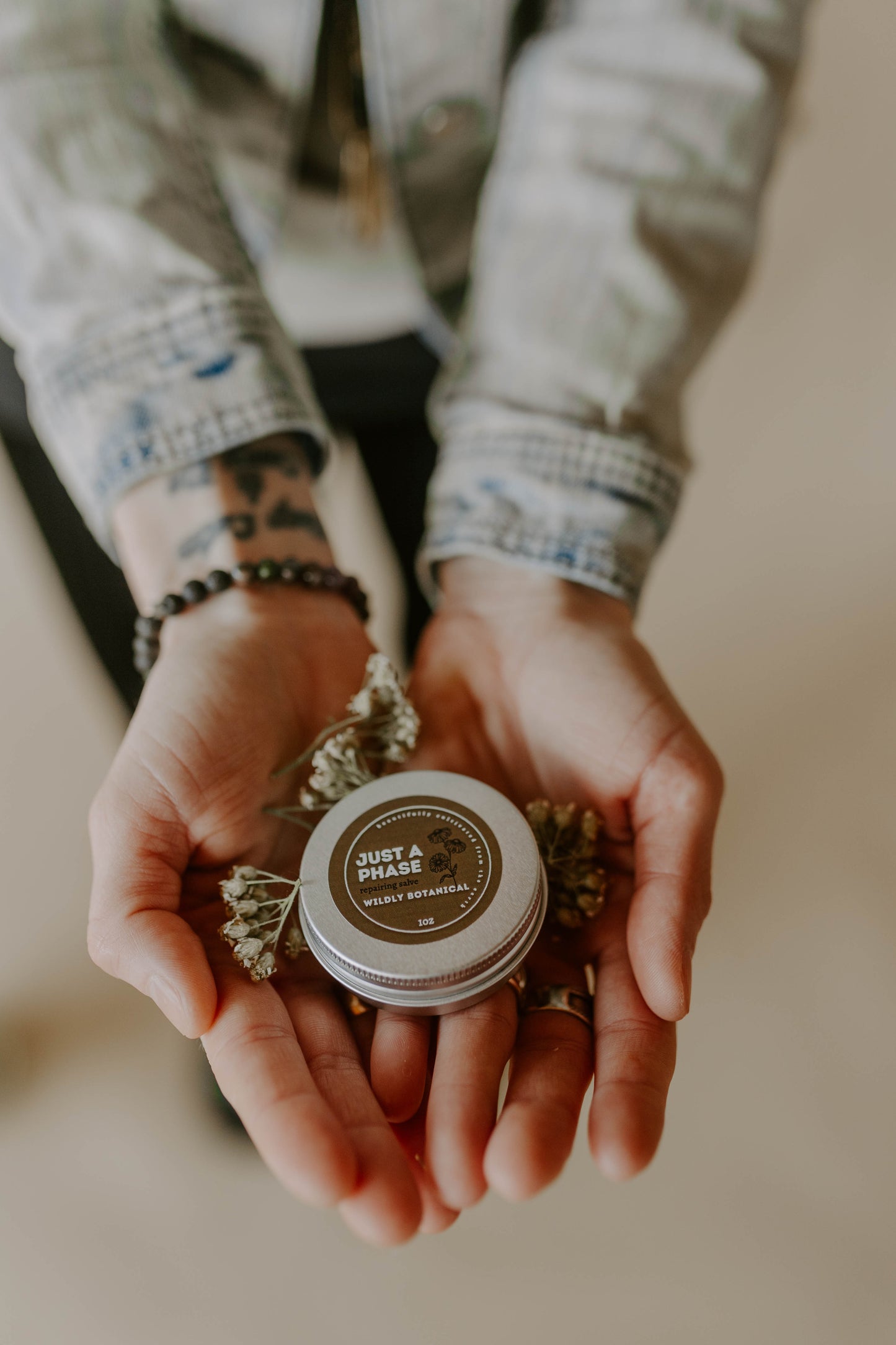 jean jacket, just a phase, tin, balm, salve, yarrow, white flower, repairing, healing, crystal bracelet, tattoo on wrist