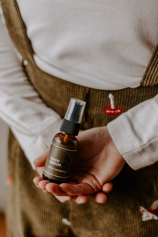 mushroom overalls, white shirt, rash serum, rash, skincare