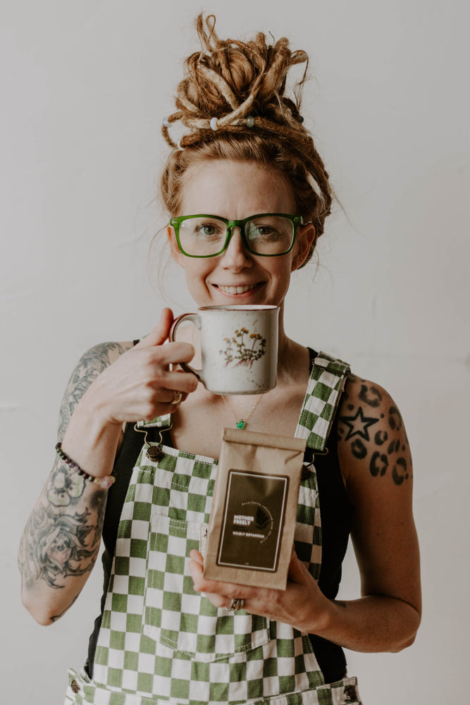 
                  
                    dreadlocks, girl with dreadlocks, green overalls, checkered overalls, green and white, crystals in hair, vintage mug, tea cup, mother freely, tea, herbal tea, hot tea, loose leaf, crystal bracelet, tattoos
                  
                